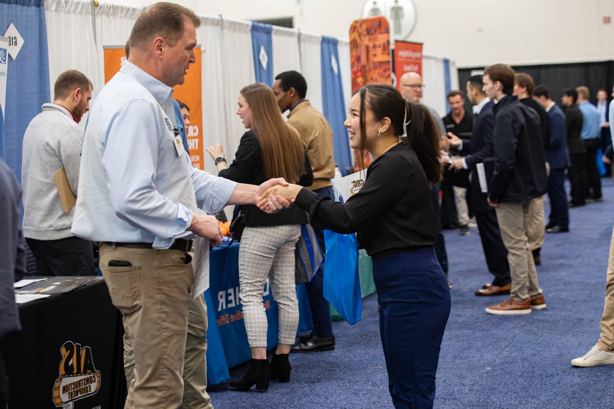 employer and student shaking hands at career fair